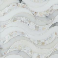 an abstract white and grey tile design with wavy lines in the center, on top of a marble slab