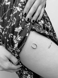 a woman's stomach with a crescent tattoo on it