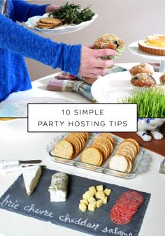 a table topped with plates and trays filled with different types of food on top of it