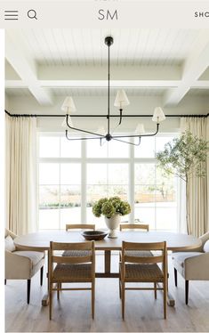 the dining room table is surrounded by beige chairs