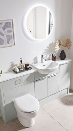 a bathroom with a sink, toilet and mirror in it's centerpieces