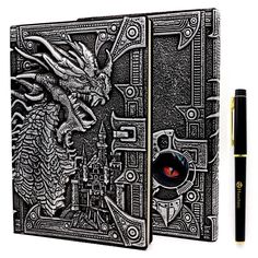 an intricately designed notebook with a pen on the side and a drawing of a dragon