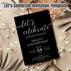 an elegant black and white celebration party card with flowers on the table next to it