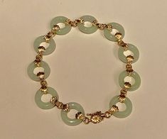 Vintage 14k gold and jade link bracelet. hallmarked 14k and designers mark and China on the lock. It has been additional tested to be 14k gold. Very nice light green colour Jade rings, which makes it look very delicate and pretty. Length is 18cm. Width of the jade rings are 1.4cm. Will be sent by registered and insured delivery free of charge. Should you wish to reach you very quickly, please let me know, and for a small charge, I can send it by DHL Express. It will be send in a luxury jewellers Luxury Jade Bracelets, 14k Gold Bangle Bracelet, Halo Bracelet, Jade Jewellery, 22k Gold Ring, Jade Rings, Lock It, Double Bass, Jade Ring