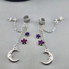 Ear Cuff Moon Ear Cuff Star Ear Cuff Dangle Ear Cuff Purple Hematite Star Silver Moon Ear Cuff Sterling Stud Earrings Pair or Single These super fun ear cuffs are brand new for me!  I watched a utube video to learn how to put them on!  It is super comfortable and lightweight. I have added right and left to the variations, so I can make sure the charm is facing the correct direction before shipping. The cuff is stainless steel. The chain is silver plated stainless steel.  The moon is silver plated and the ear post is sterling silver.  The purple star beads are electroplated hematite.  They are wire wrapped to the chain for added security. Hematite is a grounding and protecting stone.  It harmonizes mind, body and spirit.  This stone removes self-limitations and aids expansion.  They ship in Ear Cuffs, Silver Moon, Moon Earrings, Huggie Hoop Earrings, Cuff Earrings, Dream Jewelry, Ear Cuff, Violet, Hoop Earrings