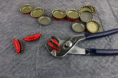 a pair of pliers and some empty beer bottle caps