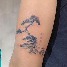 a woman's arm with a tattoo on it that has a bonsai tree