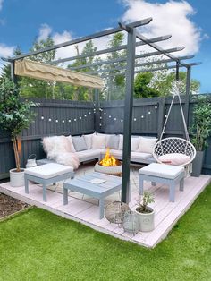 an outdoor living area with furniture and fire pit