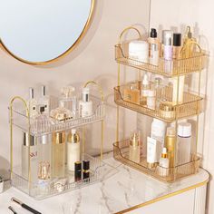 a bathroom vanity with three shelves holding various beauty products and a round mirror above it