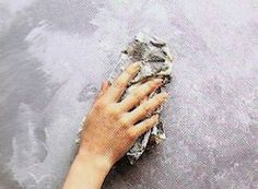 a person with their hand on a dusted surface