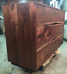 a large wooden box sitting on top of a pallet in a warehouse or workshop