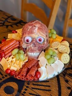 a plate that has food on it with a skull in the middle and some crackers