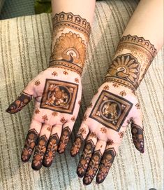 two hands with henna designs on them