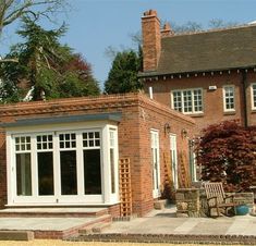 a brick house with white doors and windows