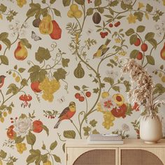 a vase with flowers and birds on a shelf next to a wallpapered wall