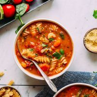 two bowls of pasta soup on a table