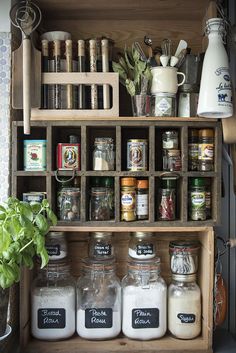 an old wooden cabinet filled with jars and spices