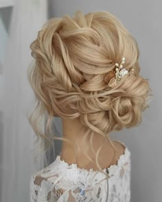 a woman with blonde hair wearing a wedding hairstyle