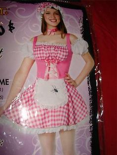 a girl in a pink and white dress is wearing an apron with a spider on it