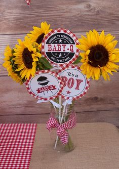 sunflowers in a vase with baby's first birthday stickers on it