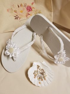 "Very simple Flat wedding sandals flipflop style 1/2\" heel. OFF-WHITE, ALSO CALLED DIAMOND WHITE. handmade flowers, the centers are a little darker than flowers; flowers are not white, flowers are Off-white. Very dressy and simple please look at the pictures. Sizes: Small: 5.5 - 6.5 Medium: 7-8 Large: 8.5 - 9.5, X-Large: 10 - 11 Please contact for any questions ON SIZING, or ANY other concerns. FINAL SALE, NO RETURNS, NO EXCHANGES, NO EXCEPTIONS." White Closed Toe Flip Flops For Beach, White Open Toe Wedding Shoes For Beach Wedding, White Sandals For Beach Wedding In Spring, Elegant White Toe Post Flip Flops, Elegant Flower-shaped Beach Sandals, Elegant White Wedding Shoes For Beach Ceremony, Adjustable White Sandals For Beach Wedding, White Round Toe Beach Wedding Shoes, White Adjustable Flip Flops For Wedding