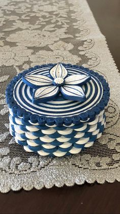 a blue and white cake sitting on top of a table