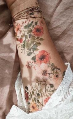 a woman's arm with flowers on it