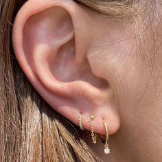 A twist on your classic gold hoops - the starry night diamond drops feature a sparkling prong set diamond charm. -14k gold -2 round sparkling prong set diamonds tcw 0.07 -10mm diameter Questions? shop@katiediamondjewelry.com Gold Hoop Ear Stack, Simple Gold Earring Stacks, Delicate Earrings Gold, Simple Curated Ear, 3 Stack Earrings, Three Piercing Stack, Gold Earring Stack 3 Holes, Simple Ear Stack, Simple Earring Stack