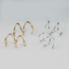 Hand crafted cork screw meant for a double ear piercing. Swirl them through two ear piercing holes for a unique take on mini hoops. Available in both sterling silver, gold fill or 10k yellow gold. A perfect gift for anyone with two sets of piercings. So comfortable you can wear them while sleeping. Can be purchased as a single or as pairs if you only have one ear with two holes. Please allow 1 week for production and shipping, unless they are in stock. Double Ear Piercing, Double Ear Piercings, Cork Screw, Double Piercing, Rings Mens Wedding Bands, Ear Piercing, Wedding Rings Vintage, Threader Earrings, Engagement Ring Wedding Band