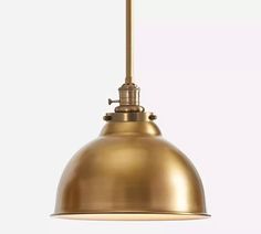 an antique brass pendant light hanging from the ceiling