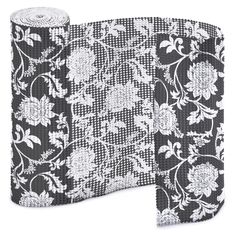 a roll of black and white lace with flowers on it