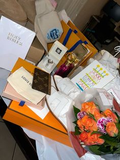 a table topped with lots of boxes and flowers