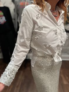 Holiday glam defined in a blouse. This crisp white button up is covered in pearls and rhinestones. Pairs perfectly with velvet, denim or leather. Diy Rhinestone Shirt, Winter Goals, Simple Work Outfits, Long Gown Design, Simple Work, Rhinestone Shirts, Mens Trunks, Holiday Glam, Girls Together