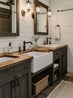 a bathroom with double sinks and wooden counter tops in the center, along with two mirrors