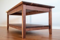 a wooden coffee table sitting on top of a hard wood floor