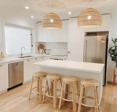 three stools are in front of the kitchen island