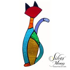 a stained glass cat sitting on top of a white background with the words silver moon behind it