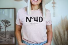 a woman wearing a pink shirt with the words no 40 on it