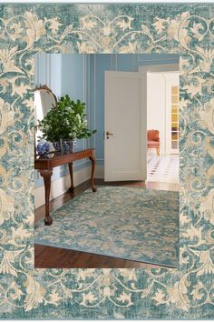 a blue and white room with an ornate rug on the floor next to a door