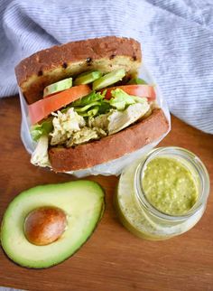 a sandwich with avocado, tomato and lettuce