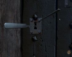 an old door handle on a wooden door