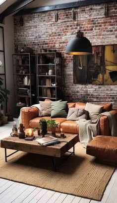 a living room with brick walls and leather furniture in the center, along with a rug on the floor