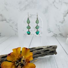 "Add a pop of green to your look with these gorgeous Chrysoprase Dangle Earrings. Perfect for dressing up or down, these earrings will have you looking effortlessly stylish. A must-have for any jewelry collection! (Can you believe the name, though? Chrysoprase? Sounds like a fancy drink, but nope, just a beautiful gemstone.)" ▪ sterling silver ▪ 2" in length Green Long Drop Earrings, Green Single Long Drop Earring, Green Bohemian Earrings For Everyday, Single Green Long Drop Earring, Green Bohemian Earrings For Everyday Wear, Everyday Green Earrings With Natural Stones, Everyday Green Dangle Teardrop Earrings, Everyday Green Teardrop Dangle Earrings, Green Teardrop Dangle Earrings For Everyday Wear