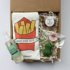 an open box containing fries, gums, and other condiments with labels on them