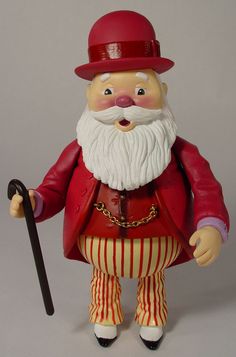 a plastic figurine wearing a red hat and holding a cane