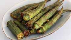 asparagus on a white plate ready to be eaten with pesto seasoning