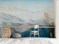 a room with a painting on the wall and a chair next to it in front of a desk