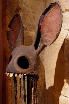 an animal mask is hanging on the wall