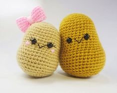 two crocheted stuffed animals sitting next to each other