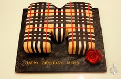 a birthday cake made to look like shoes with a rose on the bottom and plaid pattern